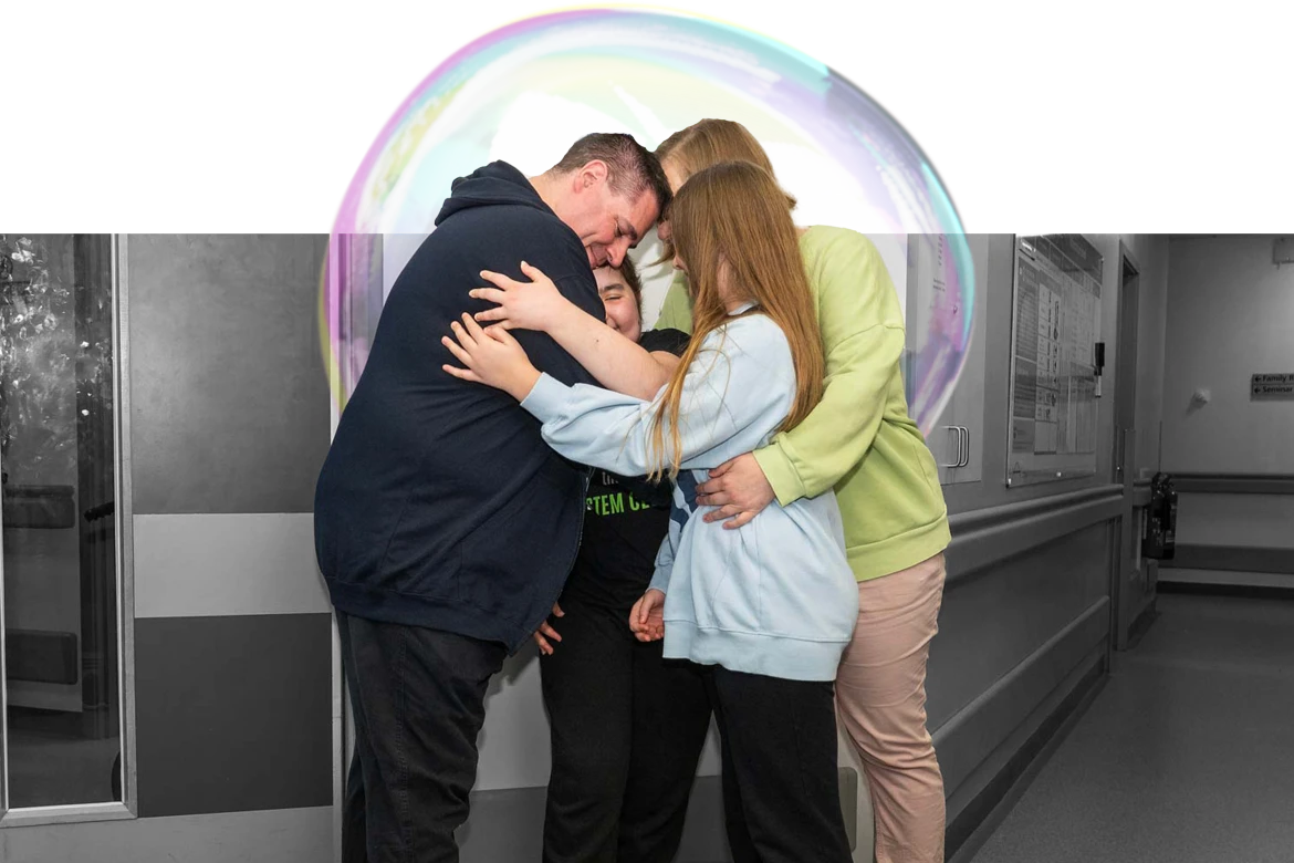 Lexi and her family hugging after discharge