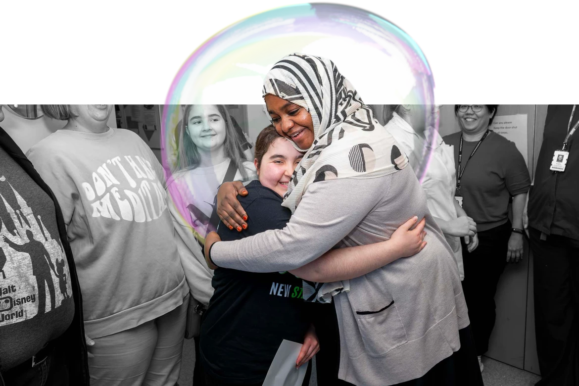 Lexi hugging a Ward 3 staff member