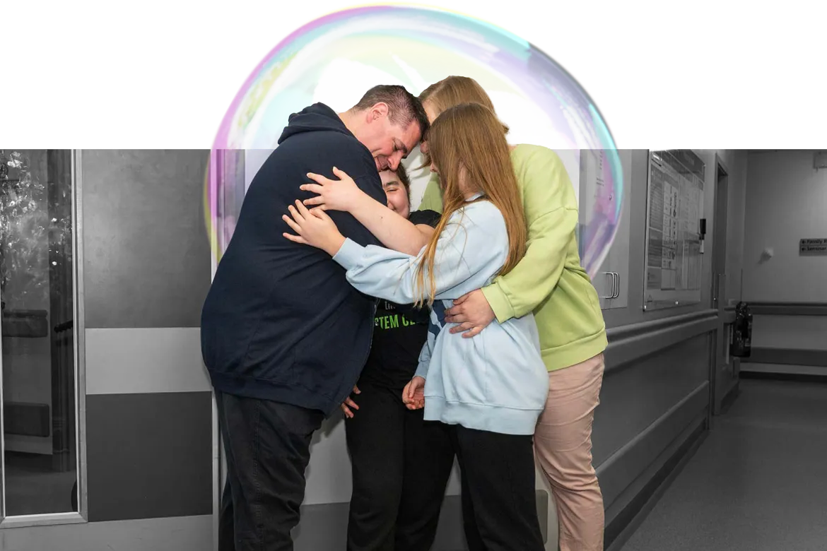 Lexi and her family hugging after discharge