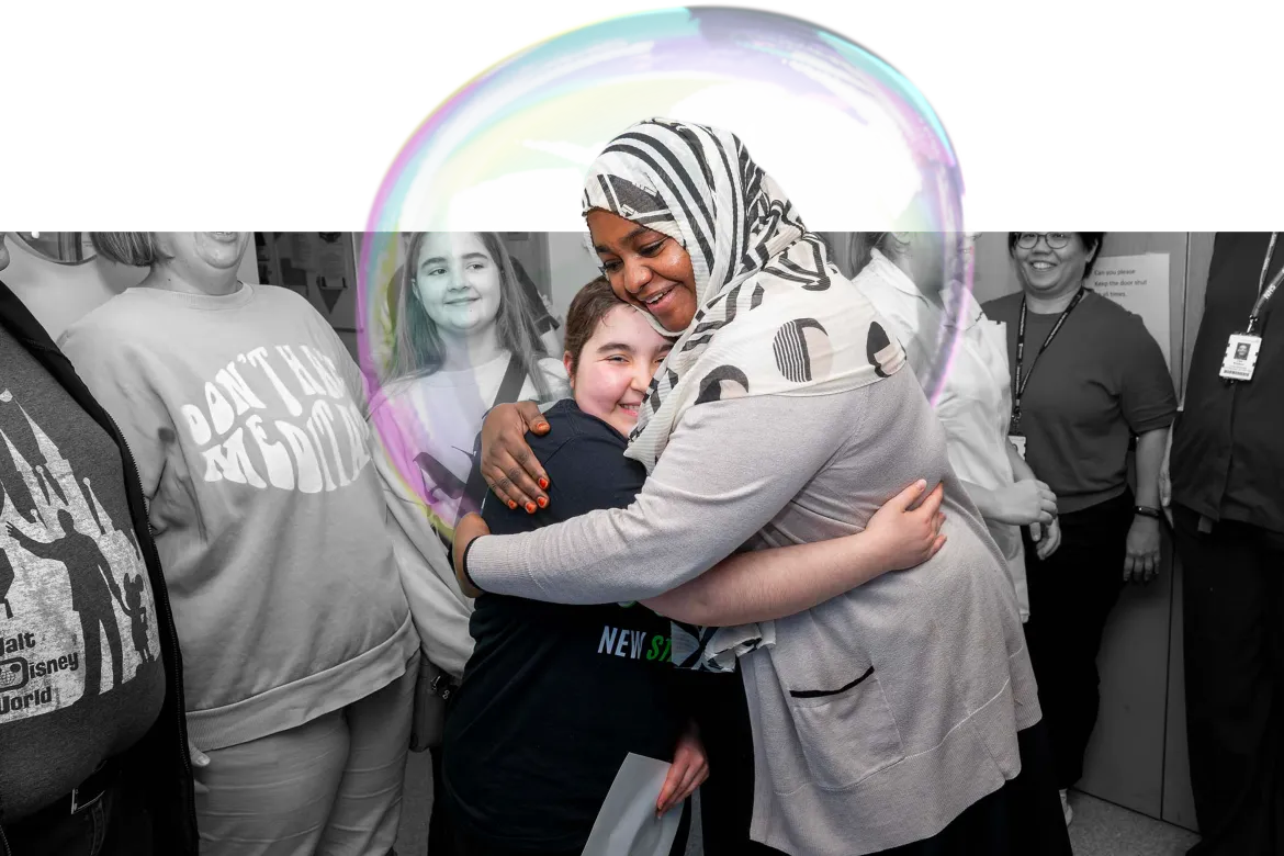 Lexi hugging a Ward 3 staff member