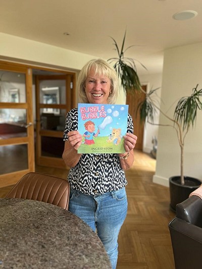 Author Ingrid Stow holding book