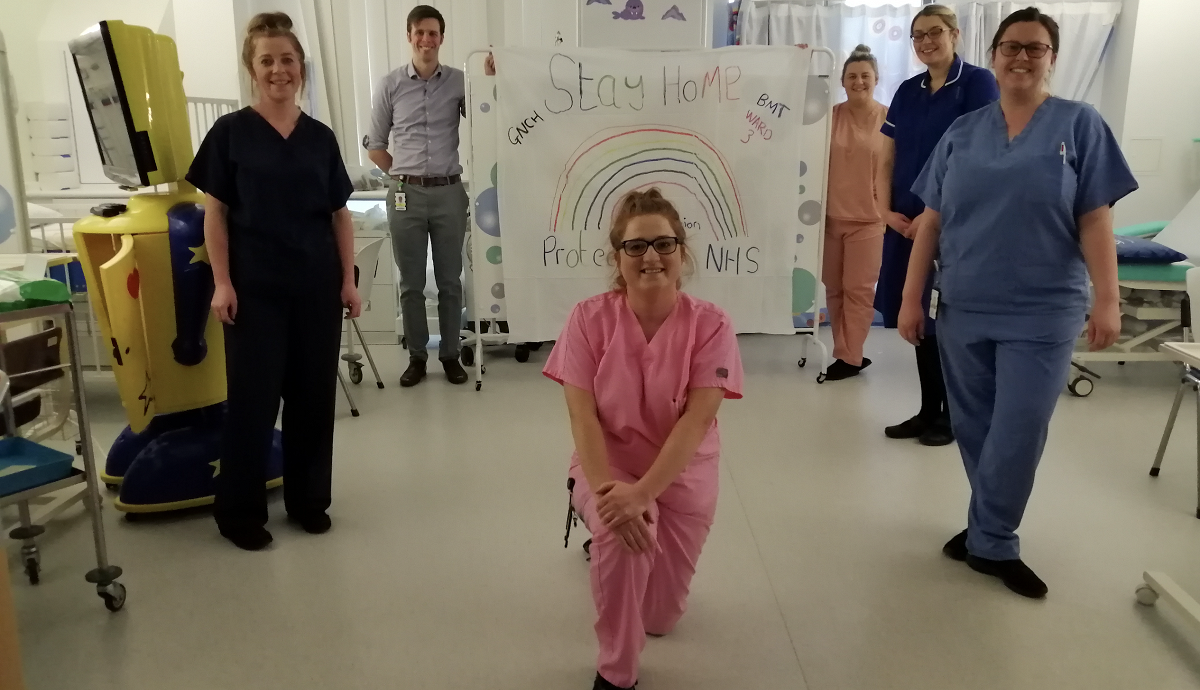 NHS Nurses with rainbow. Stay at home.